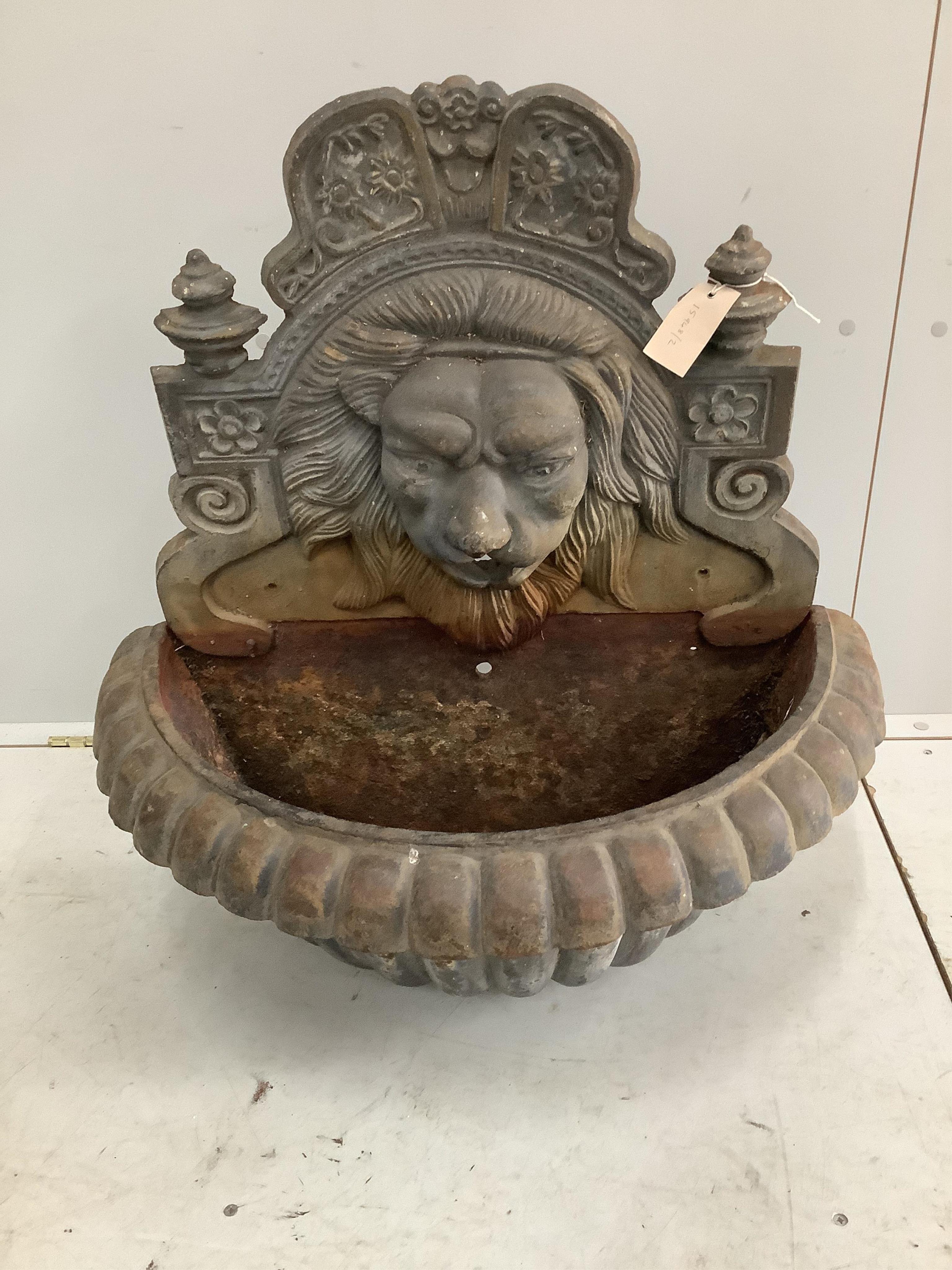 A cast iron lion mask wall fountain, width 68cm, height 74cm. Condition - fair